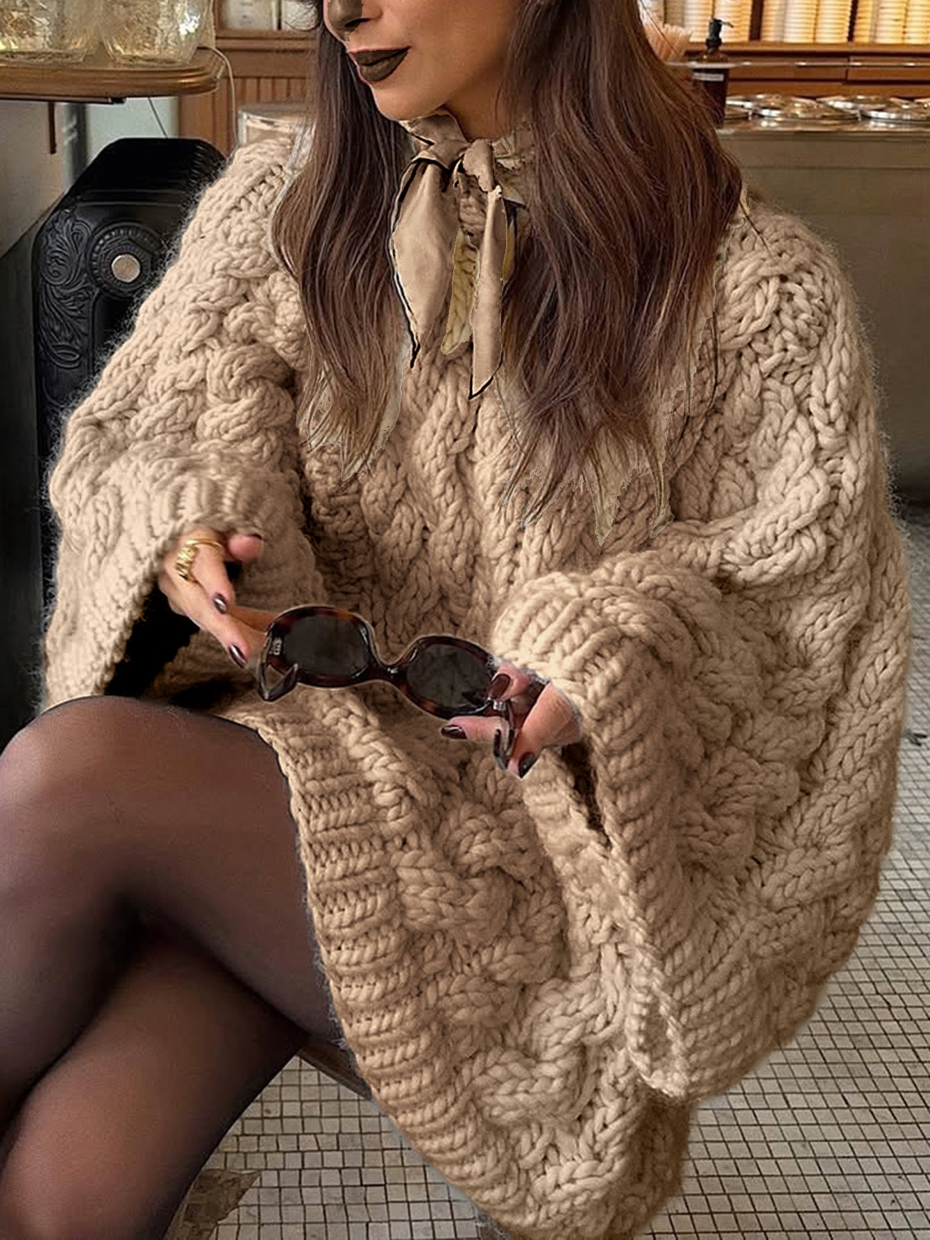 Beige oversized cable knit long sleeve sweater with sunglasses
