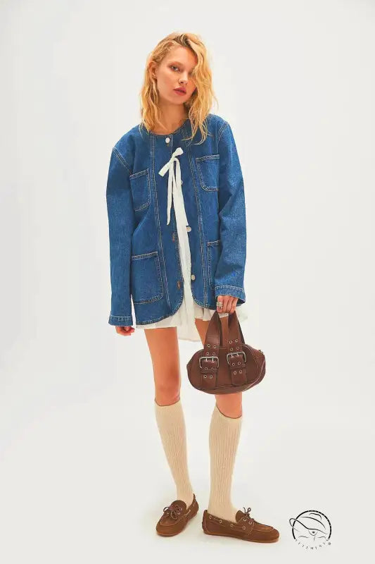 Woman in casual fashionable cowboy coat with white dress, socks, loafers, bag