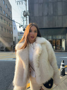 Short loose casual faux fur coat with white trim and Chanel bag