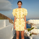 Yellow puff sleeve mini dress featuring a floral pattern, ideal for summer fashion