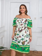 Elegant bohemian dress: woman in white off-shoulder midi with green border and bird floral patterns