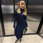 Woman in a navy maxi dress showcasing elegant style and fashion sophistication