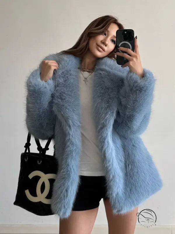 Light blue fluffy faux fur coat with Chanel handbag