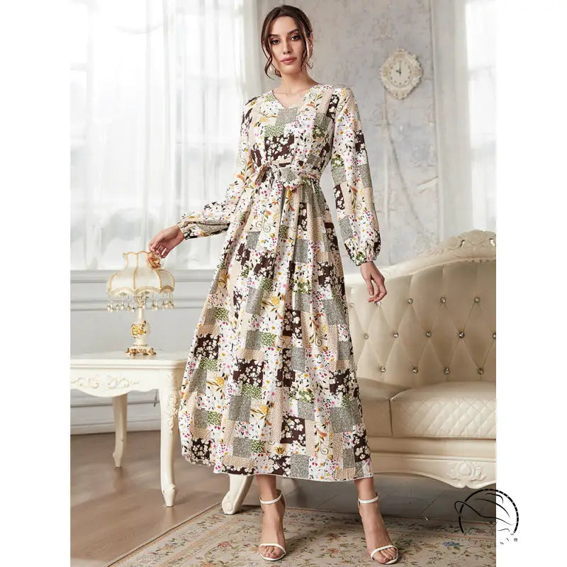 Woman in floral print slim fit maxi dress with patchwork botanical motifs