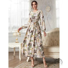 Woman in floral print slim fit maxi dress with patchwork botanical motifs