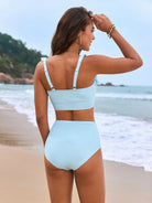 Light blue high-waisted bikini set with sports bra top, perfect for stylish summer fashion