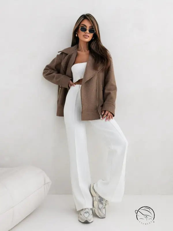 Woman in langry collared woolen brushed zipper coat in brown jacket and white pants