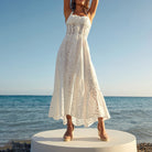 White eyelet midi dress for women, embodying fashion with a slimming design and embroidery