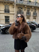 Gorgeous faux fur Langry fox jacket with black pleated skirt and sunglasses