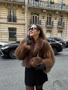 Gorgeous langry faux fur fox jacket with black pleated skirt and sunglasses