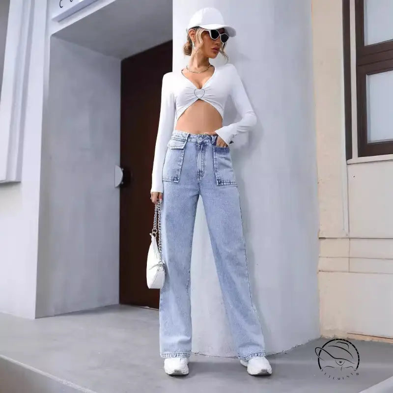 Woman in white crop top and Langry denim trousers with baseball cap