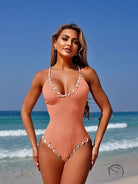 Stunning matching sling peach ribbed one-piece swimsuit with white shell trim