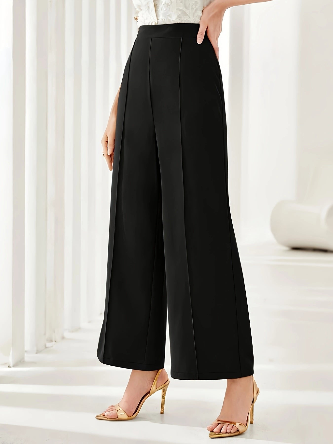 Black wide leg cropped dress pants styled with nude strappy heels for elegant fashion