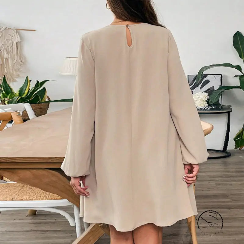 Woman in comfortable beige midi dress with keyhole back neck