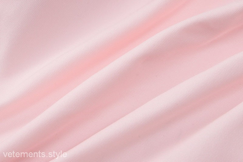 Wrinkled pink fabric of HALTER LOW CUT RUFFLED DRESS showcasing sexy halter low design