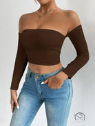 Woman in off-shoulder camisole waist trimming short sleeve crop top