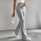Person in casual knitted match pants, white sneakers, small white handbag