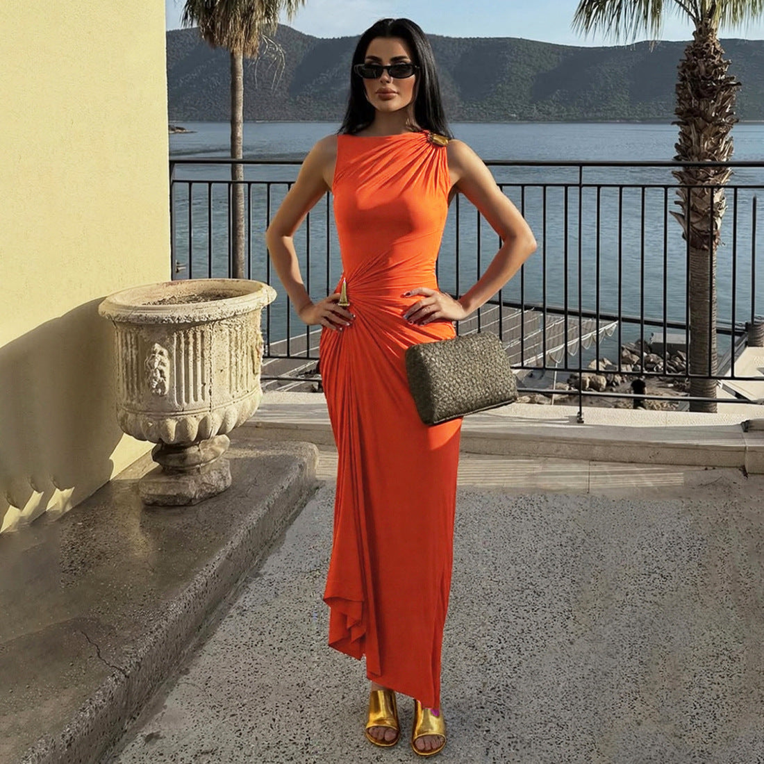 Elegant langry fashion sleeveless maxi dress in orange with gold heels and clutch