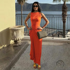 Elegant langry fashion orange sleeveless maxi dress with gold heels and clutch