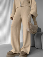 Enchanting Langry fashion beige ribbed knit sweater and wide leg pants set with fur-trimmed bag