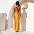 Mustard yellow satin dress with halter neck and tie-up back