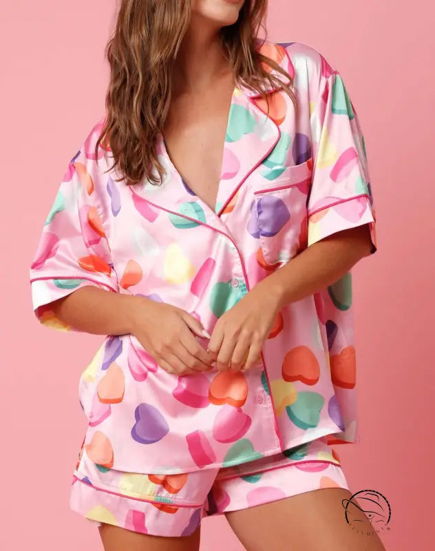 Cute two piece set pajamas in pink satin with heart print and red piping