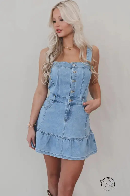 Office suspenders denim dress in light blue with button-front bodice and ruffled hem