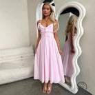 Pink spaghetti-strap midi elegant loose dress with fitted bodice and flowing skirt