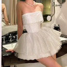 Sparkly white strapless mini dress showcasing elegant off shoulder fashion ملابس