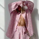 Pink heart-patterned pajamas set with ruffled long sleeve shirt and elastic-waist shorts