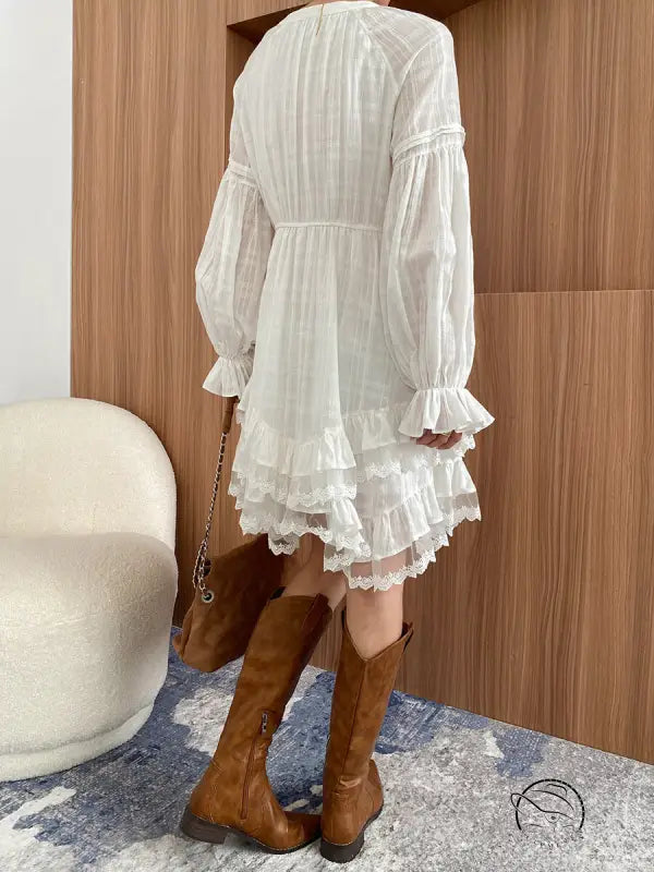 Stunning white layered dress with ruffles and brown boots