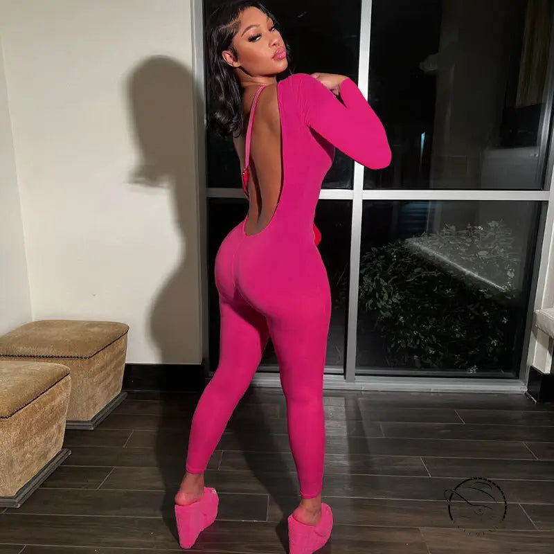 Woman in pink backless slim fit jumpsuit and platform shoes