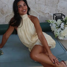 Woman in stunning backless mini dress, yellow halter style