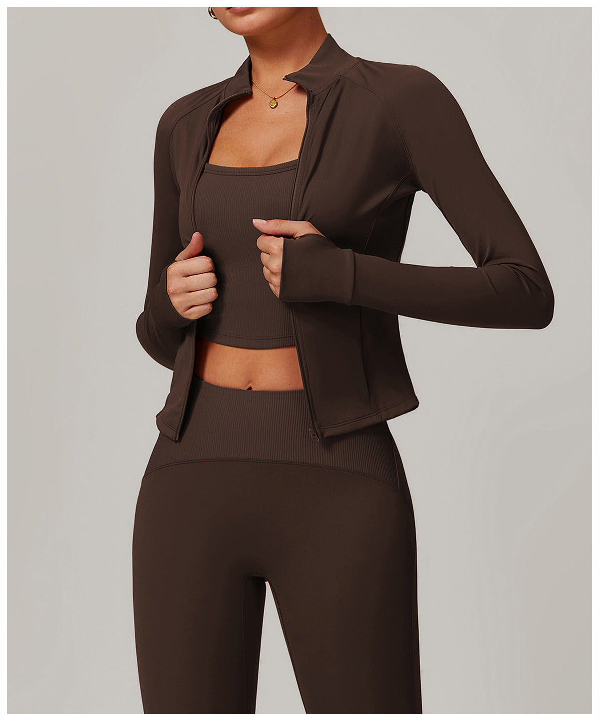 Brown langry three-piece athletic set featuring a cropped jacket, sports bra, and leggings