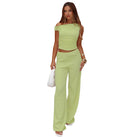 Woman in a light green two-piece outfit, showcasing fashionable ملابس from Langry