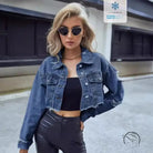 Woman in matching denim short coat with tube top and dark pants