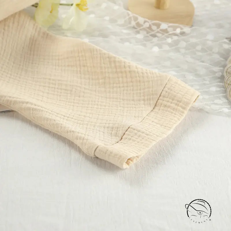Close-up of beige textured winter pure cotton pajama sleeve with cuff