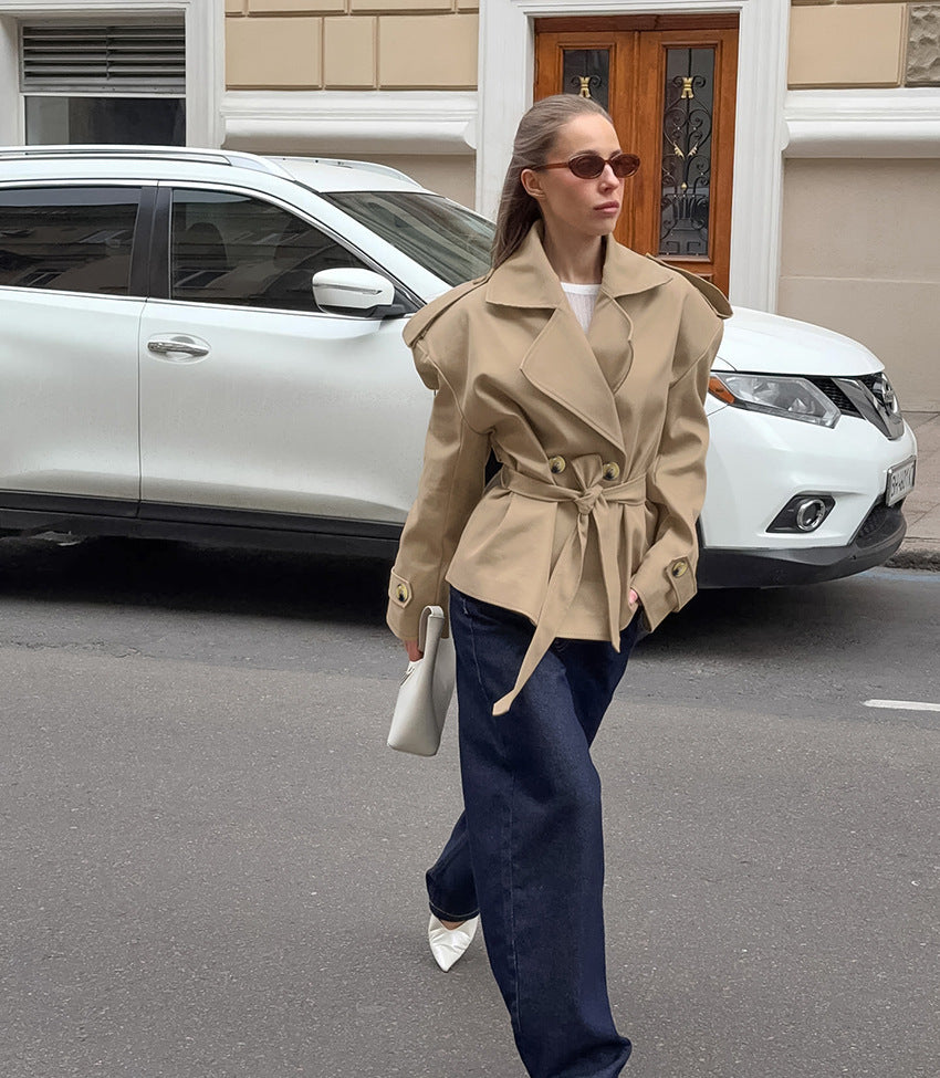 Trendy beige khaki trench coat with double-breasted fashion design and belt detail