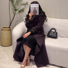 Black quilted handbag with gold-tone hardware in Langry fashion trench coat