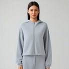 Light blue hooded zip-up jacket, a stylish choice for women’s autumn fashion ملابس