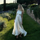 White polka dot halter neck satin maxi dress with floral lace hem