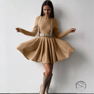 Beautiful woolen knitted dress on woman in tan dress with harness