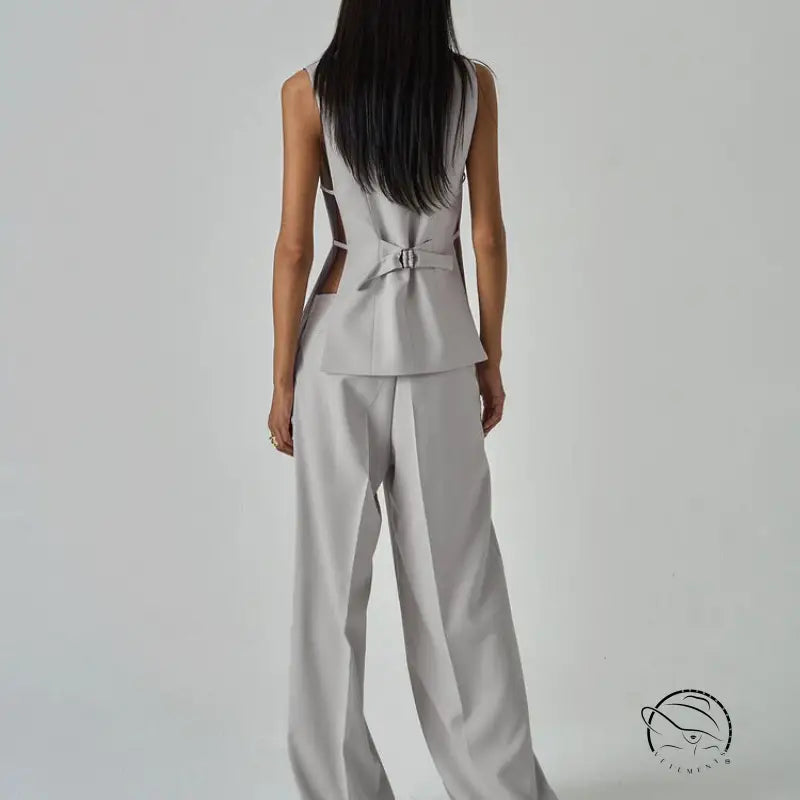 Sleek light gray long sleeve fashion jumpsuit with peplum waist and back cutouts