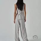 Sleek light gray long sleeve fashion jumpsuit with peplum waist and back cutouts