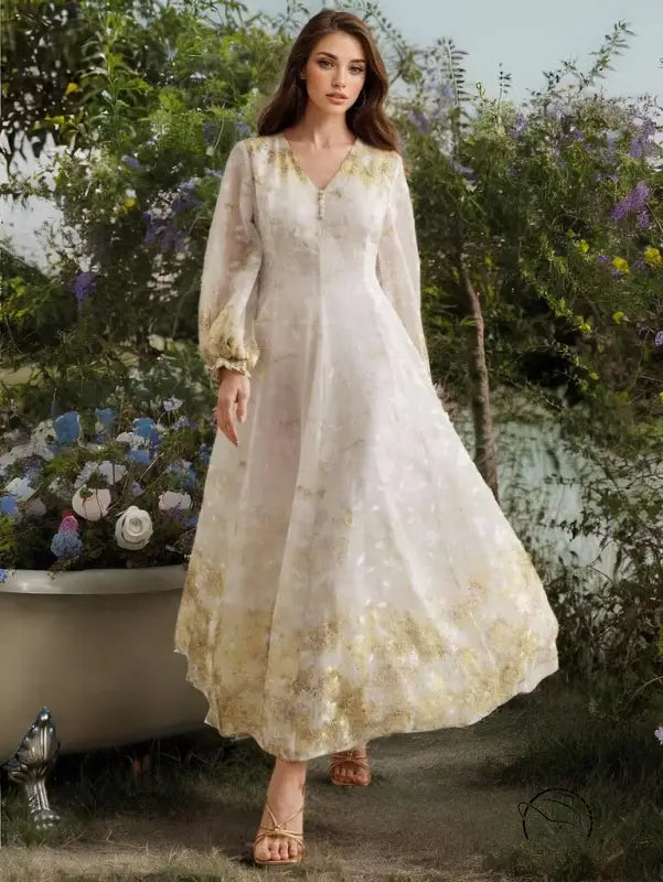 White embroidered organza maxi dress with gold accents and lace details