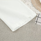 Crisp white cotton langry nightgown fabric with subtle texture and folded edge