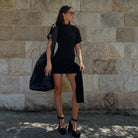 Woman in black mini dress showcasing Beautiful Half Sleeve Short Dress for fashionable style