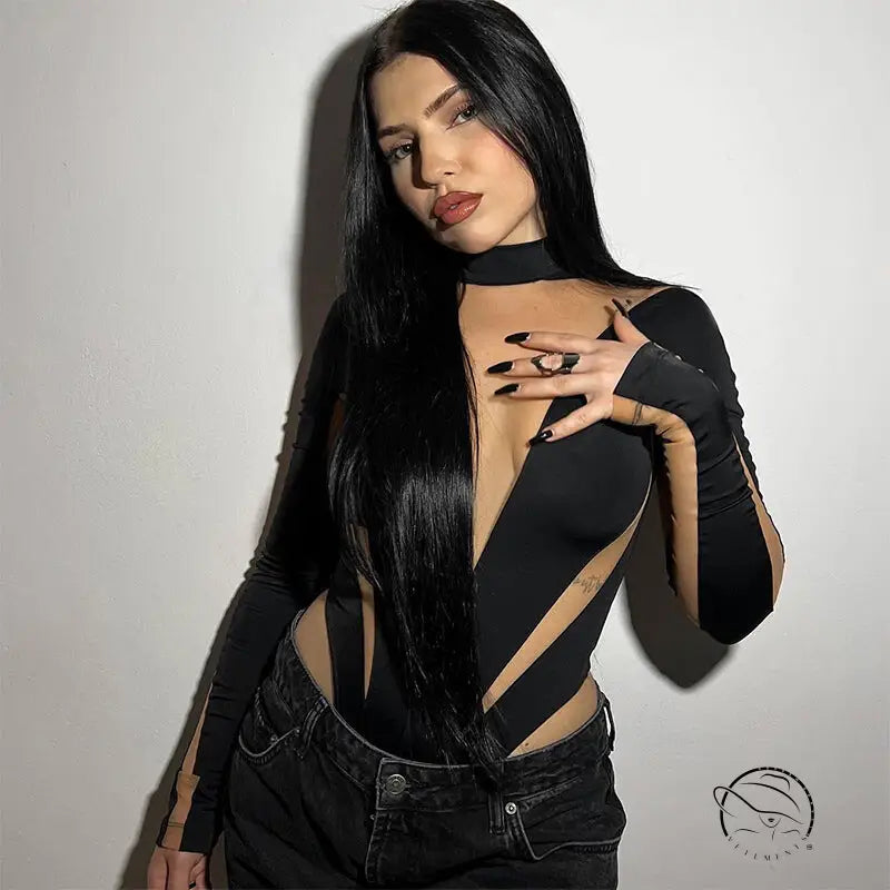 Woman in black cutout bodysuit with mesh stitching, high waist, long sleeves