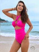 Stunning hot pink one piece swimsuit with asymmetrical cutout and crisscross straps