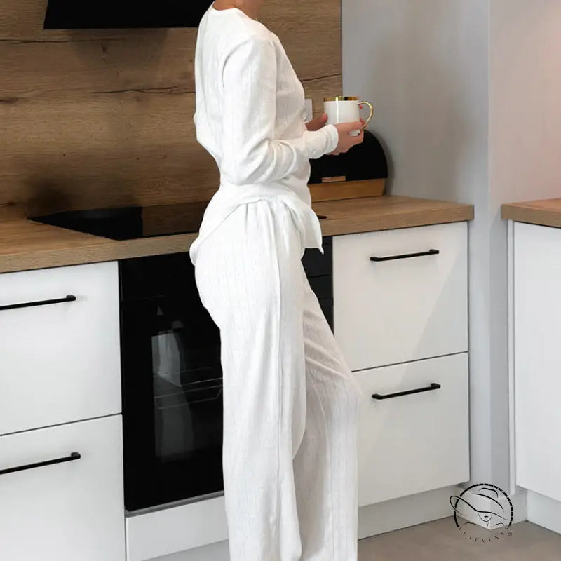 Woman in knitted jacquard pajamas with white ribbed top and wide-leg trousers